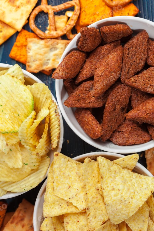 Preview: Scattered beer snacks assortment on blue wooden background