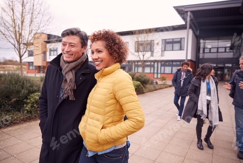 Preview: Group Of Smiling Mature Students Walking Outside College Building