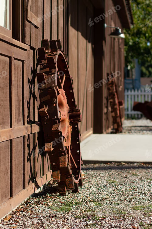 Preview: Image of two brown wheels leaning on the woody building