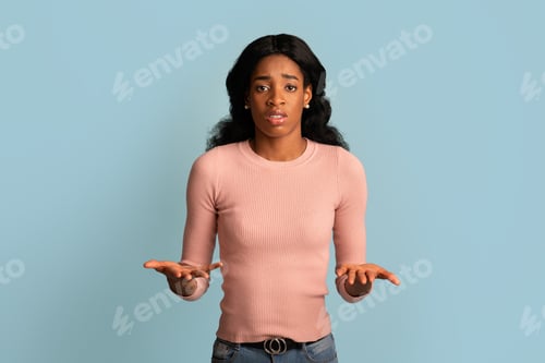 Preview: I Don't Know. Unsure Young Black Female Shrugging Shoulders And Spreading Arms