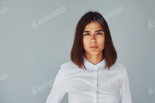 Preview: Young modern woman in white shirt standing inside of the studio