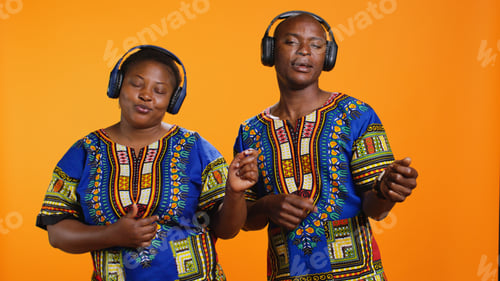 Preview: Ethnic couple pretending to play air guitar on camera