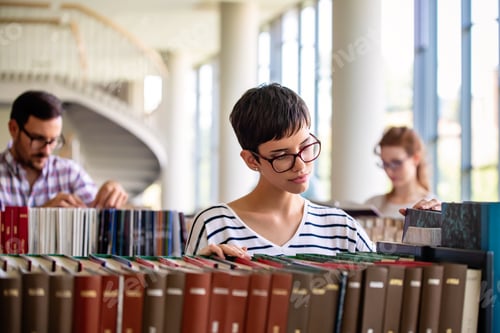 Preview: Students studying in library. Young success people are spending time together and learning together.