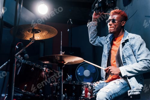 Preview: Plays drums. Young african american performer rehearsing in a recording studio
