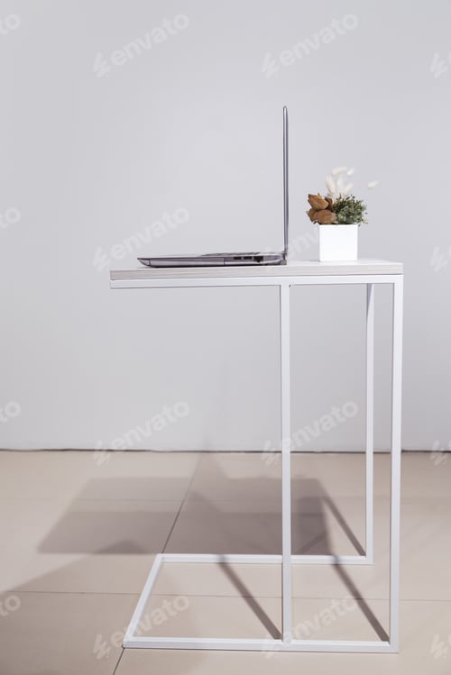 Preview: Minimalist lifestyle. laptop on coffee table side view with copy space in background