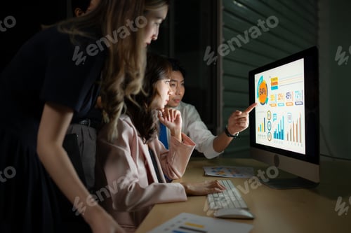 Preview: Group of business people working in office at night. Business concept.