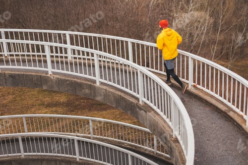 Preview: Man jogging on a bridge in the morning
