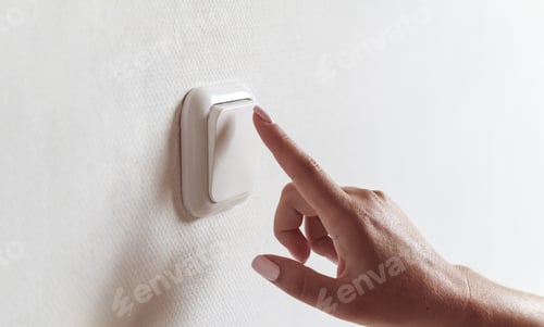 Preview: Female hand turns off the light indoors. Electrical energy savin