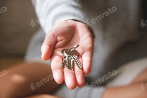 Preview: Closeup image of a hand holding the keys for real estate concept