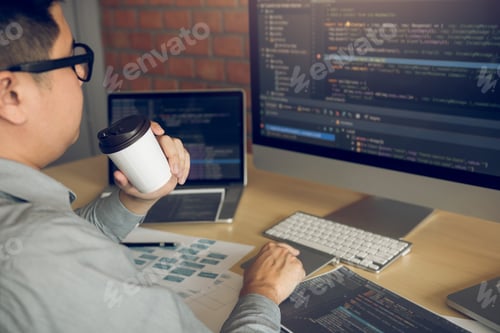 Preview: In the morning of work with a program developer holding a coffee at the office