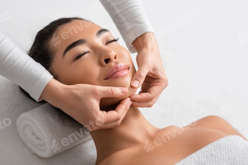 Preview: Face Lifting Massage. Young Korean Woman Getting Beauty Treatments At Cosmetology Cabinet