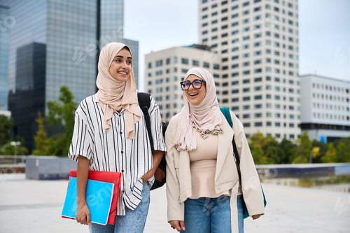 Preview: Muslim women students walking together at university campus