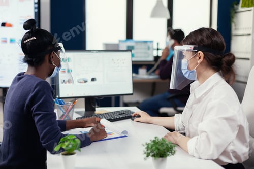 Preview: Business people using computer with financial graph