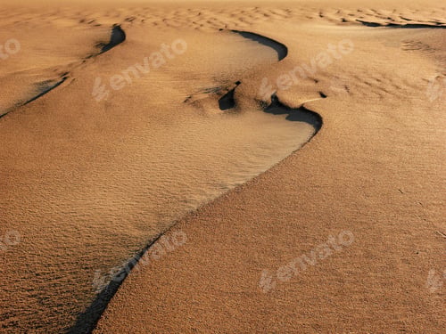Preview: Aerial view of sand dunes creating lines and shapes under the sunlight