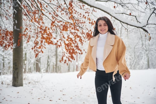 Preview: Happy woman is in the winter forest