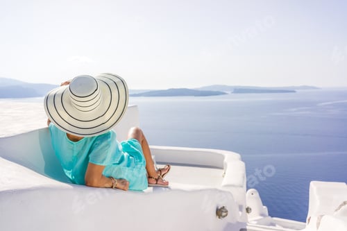 Preview: Woman Relaxing on Rooftop Overlooking Ocean