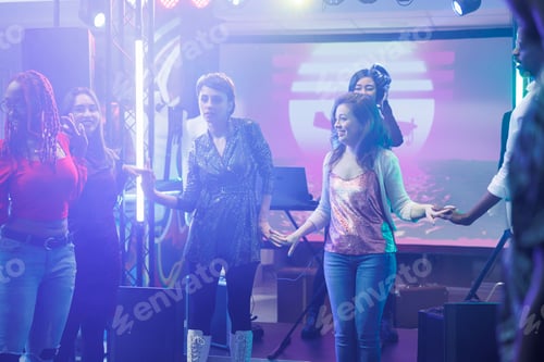 Preview: Clubbers holding hands and dancing