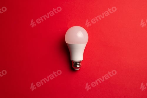 Preview: Top view of an electric light bulb on a red background