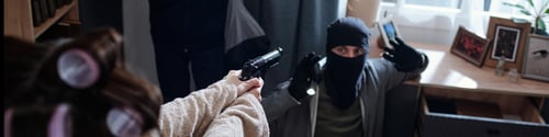 Preview: Caucasian Woman Confronting Masked Burglar Surrendering with Raised Hands