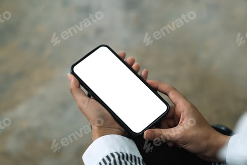 Preview: Woman sitting holding a smartphone blank white screen at the office.