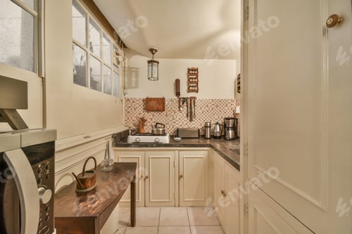 Preview: a kitchen with white cabinets and a stove and sink
