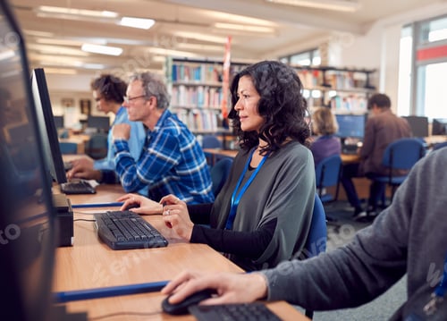 Preview: Group Of Mature Adult Students In Class Working At Computers In College Library