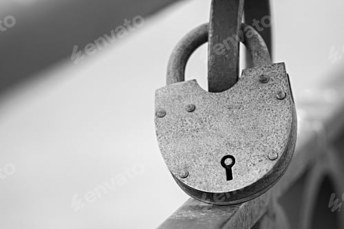 Preview: Big Gray Rusty Vintage Padlock Is Fixed In The Locked State On An Iron Fence And Has A Keyhole
