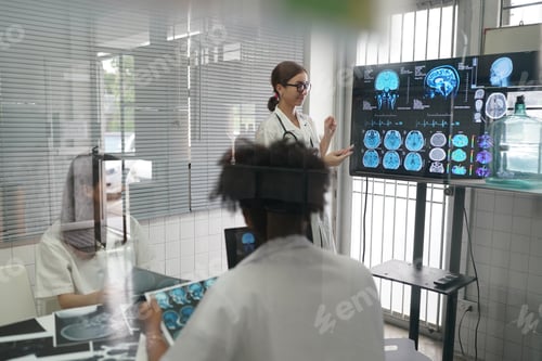 Preview: Group of doctors looking at X-ray on medical conference, discussing issues