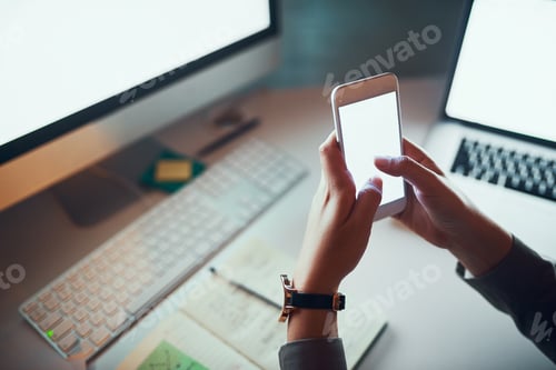 Preview: Cropped shot of an unrecognizable woman using a cellphone in the office