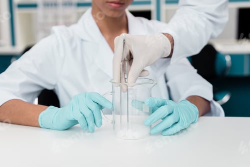 Preview: Cropped shot of colleagues in white coats working with reagent in chemical lab