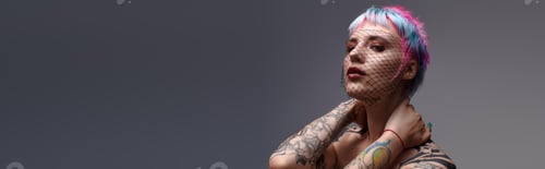 Preview: Unique style shines through colorful hair and tattoos in a modern studio setting