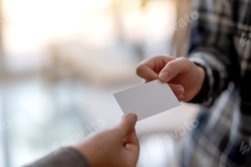 Preview: Two businessman holding and exchanging empty business card