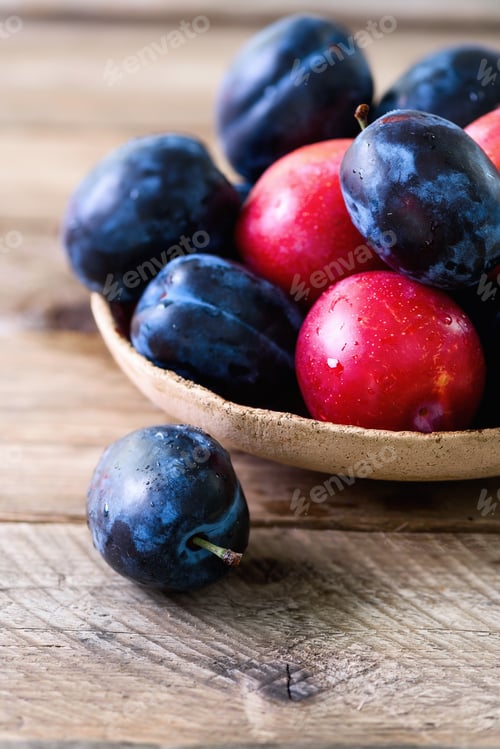 Preview: Fresh Plums in a Rustic Wooden Bowl