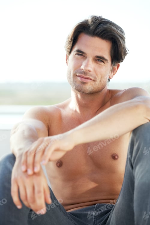 Preview: Just taking it easy. A sexy young man without a shirt gazing into the distance.