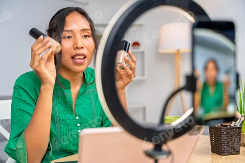 Preview: Influencer showing beauty products during livestreaming makeup tutorial