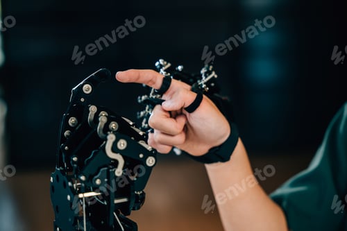 Preview: In a technical college an enthusiastic Asian teen boy tests a robot hand and arm embracing