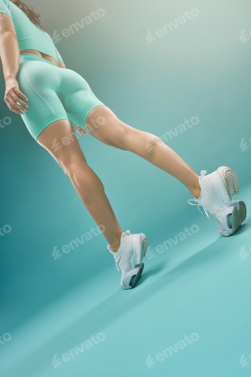 Preview: Athletic fit young woman demonstrating her slender legs