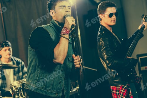 Preview: handsome man singing song near stylish rock band