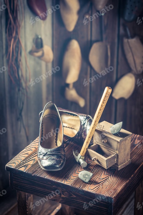 Preview: Rustic shoemaker workplace with tools, leather and shoes