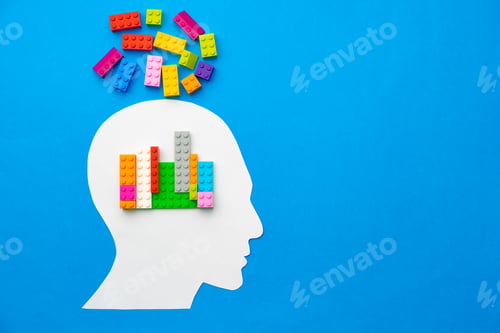 Preview: Papercut silhouette of human head with colorful constructor pieces