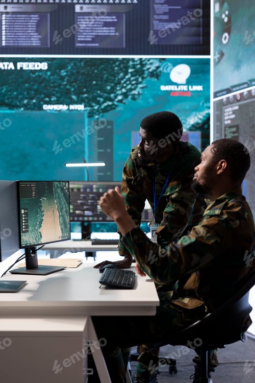 Preview: Team of army experts in a command post power base monitors satellite footage
