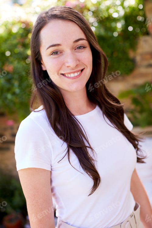 Preview: Portrait Of Smiling Woman At Home In Garden Against Flaring Sun