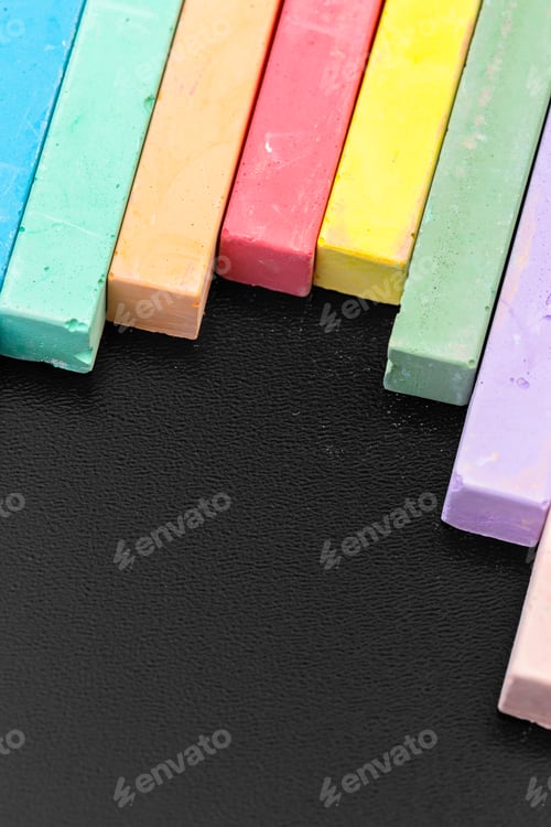 Preview: Set of colored chalks over a black background