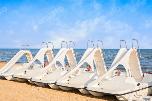 Preview: Pedal-boats with water slides on the beach.