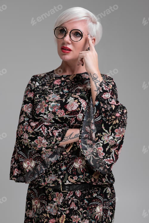 Preview: Portrait of young blonde girl with glasses isolated on light background