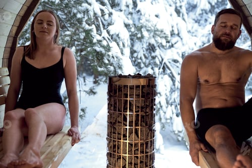 Preview: Caucasian adult couple enjoying in the sauna in winter