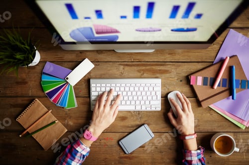 Designer at Desk Working with Color Swatches