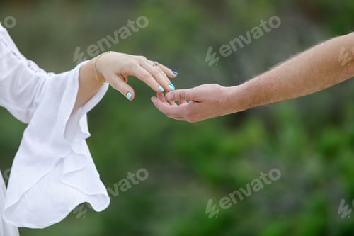 Preview: Man and woman touching hands