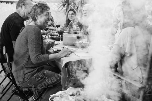 Preview: Happy family eating together at barbecue dinner outdoor