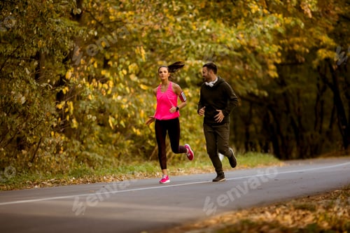 Preview: Fit Couple Jogging Through Colorful Autumn Park